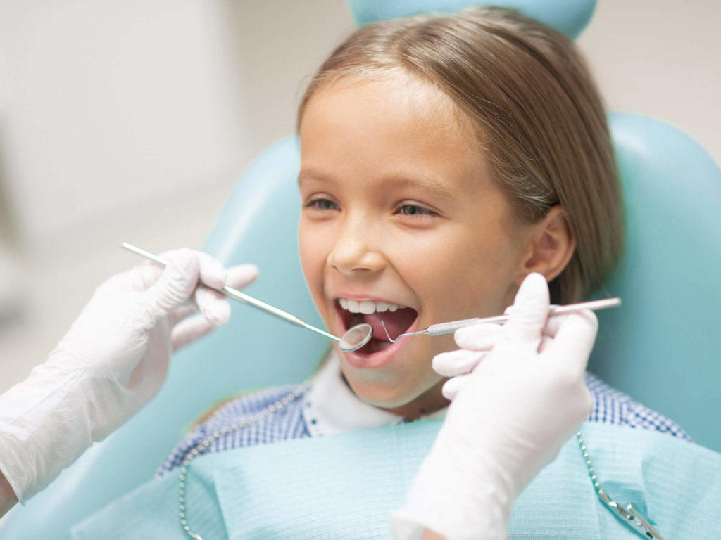A young girl getting a dental checkup