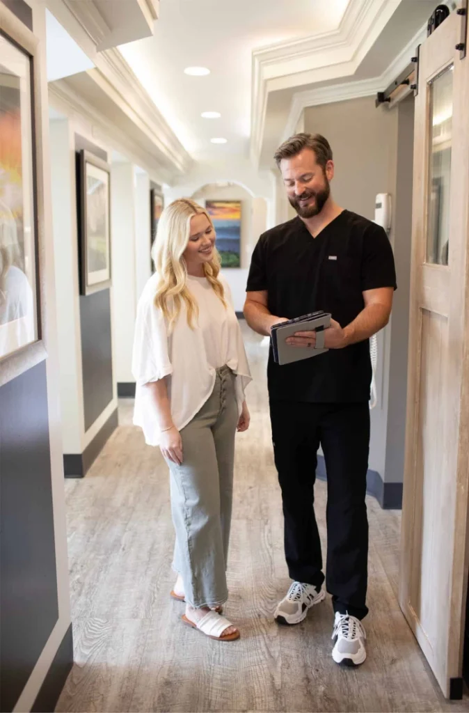 Dr. Josh Hall walking with a patient down the hallway of Hall Dental in Birmingham, AL.